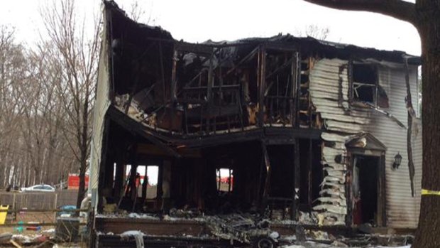 The remains of a home hit by a private jet in Gaithersburg, Maryland, on Monday.