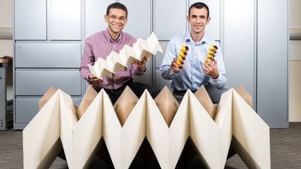 Glaucio Paulino (left) with Evgueni Filipov and their engineering origami prototypes.