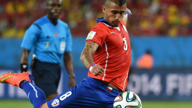 Back in side to take Brazil: Chile's powerful midfielder Arturo Vidal.