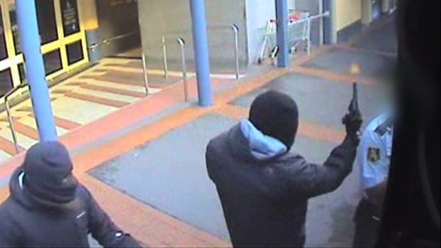 CCTV captures the moment an armed robber fires a gun next to a security guard during an attempted robbery of a cash-in-transit van near Broadway Shopping Centre in Glebe on March 4, 2013.