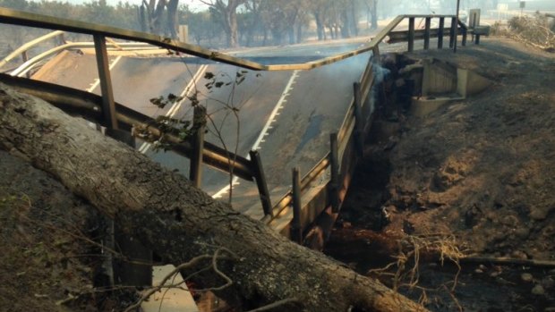 The intense heat of the bushfire has caused the Samson Brook bridge asphalt to buckle and collapse.