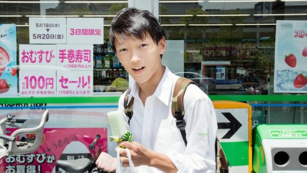 A teenager in Kawasaki, Japan, eating a Garigari-kun, a popular ice cream bar. The price of the bar was recently raised for the first time in a quarter-century.