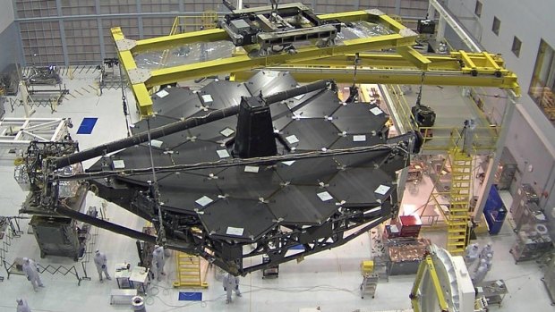 The telescope's huge mirror is carefully installed.