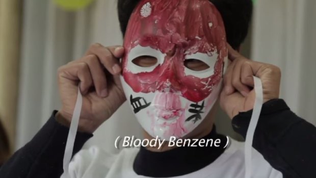 In the film, 'Who pays the price?' a protester objects to the use of benzene in smartphone production.