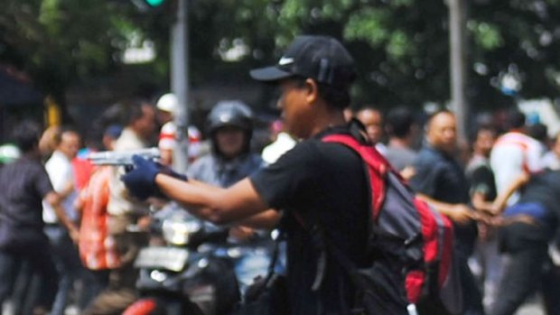 One of the suspected attackers turning his gun on the crowd. 