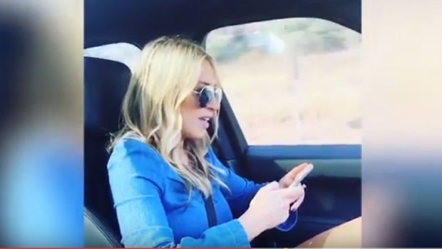 Sam Burgess' wife Phoebe sings along to Cold Chisel's <em>Khe Sanh</em> while the footballer films her apparently while he is driving.