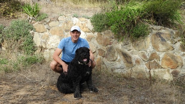 Brendan Greenwood, with his black dog Boston, is running from Sydney to Canberra to raise funds and awareness for mental health support.