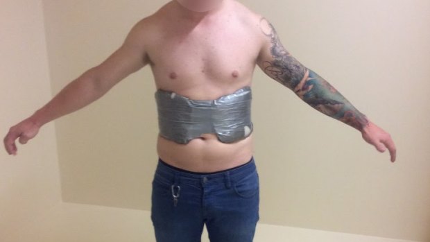 A 20-year-old Mackay man was allegedly located with a suspicious package strapped to his torso at the Brisbane Domestic Airport.