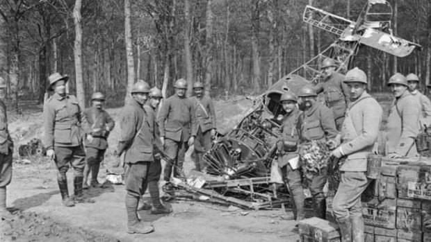 French and Australian soldiers alongside the wrecked Sopwith Camel aeroplane near Villers-Bretonneux, France, 8 May 1918. 