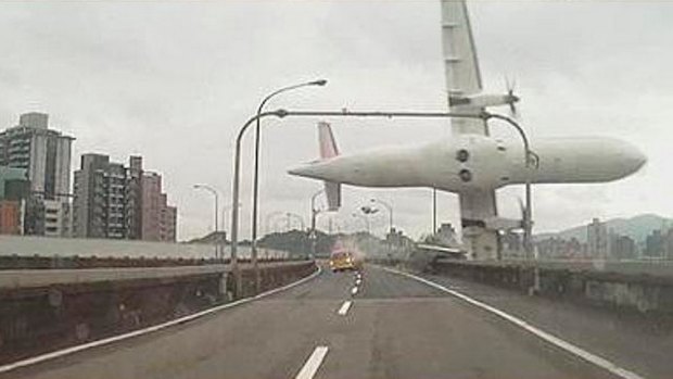 A TransAsia plane clips an overpass and a taxi before crashing. 