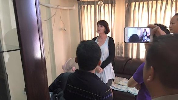 Tammy Davis-Charles being questioned in the Cambodian police office of human trafficking.