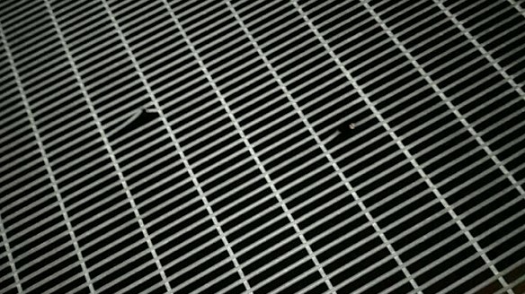 Bullet holes puncture a fence at the Manus Island detention centre.