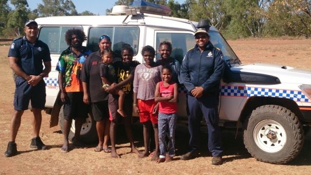 The heroic police officers pose with the group they saved in far north Queensland.