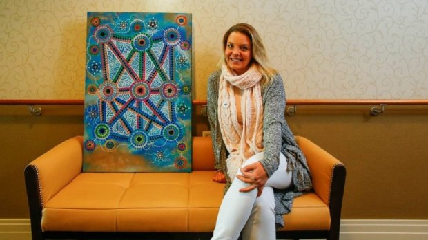 Lani Balzan with her painting that won the 2016 National NAIDOC poster competition. Her original work was destroyed in the fire. 