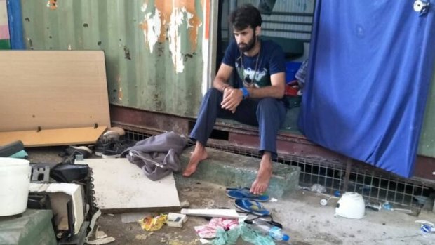 A man inside the decommissioned detention centre, where belongings were reportedly trashed in a police operation on Thursday.