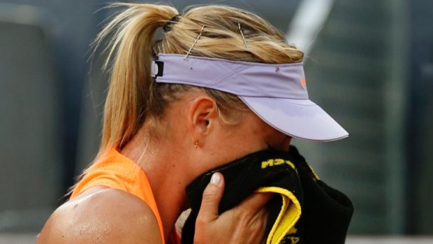 Maria Sharapova wipes the sweat away during her match against Eugenie Bouchard