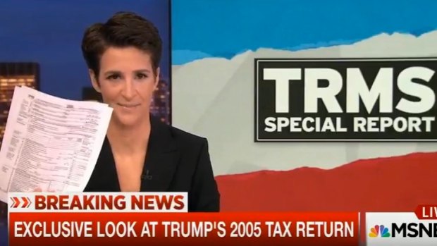 MSNBC host Rachel Maddow holds up the documents purported to be Donald Trump's tax return.