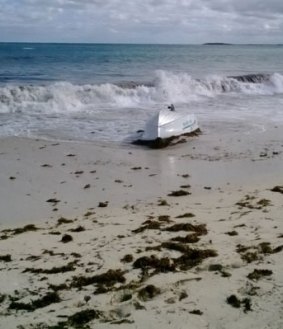The overturned dinghy.