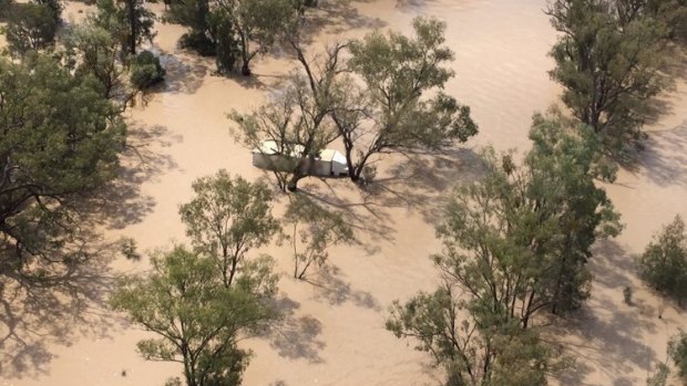 A man was rescued from the roof of his truck by a helicopter after becoming stranded in floodwaters.