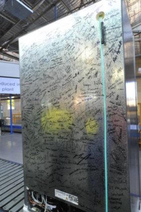 Workers' signatures on the last fridge to roll off the production line at the Electrolux plant in Orange.