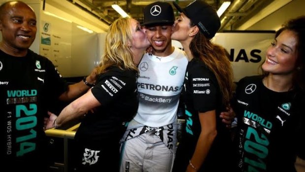 Me, me, me: Formula 1 world champion Lewis Hamilton is kissed on the cheek by his stepmother Linda Hamilton and girlfriend Nicole Scherzinger. 