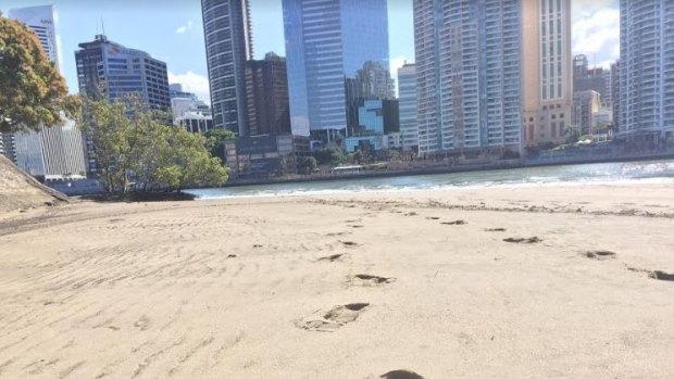 Footsteps in the beach sand at Brisbane River's CBD beach, under the Story Bridge.