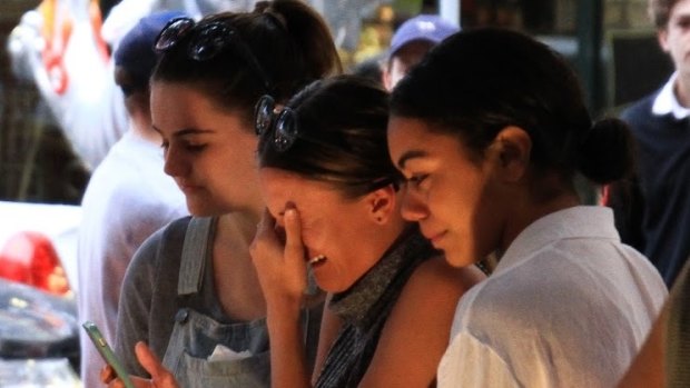 Friends of Cole Miller grieve his death at a vigil in Chinatown Mall.