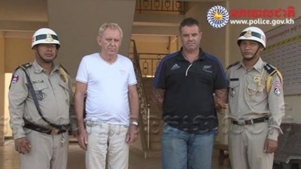 Victorian man Guido James Eglitis (left) and another foreign suspect under arrest in the Cambodian town of Siem Reap last year.