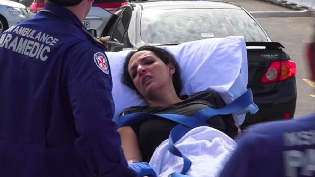 Innocent bystander: a woman receives treatment after the Bankstown shooting.