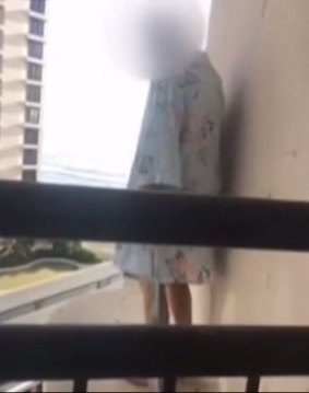 Girl out on the ledge at an apartment on the Gold Coast.