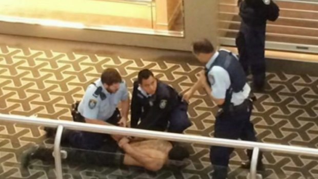 Police handcuff Kazem Payam in Westfield Parramatta after the stabbing death of Nabil Naser.