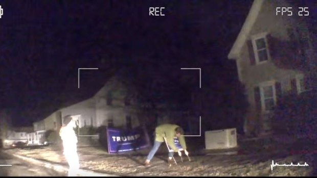 An Australian worker removes Donald Trump campaign signs.