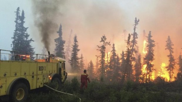 Firefighters tackle a wildfire near the town of La Ronge, Saskatchewan. 