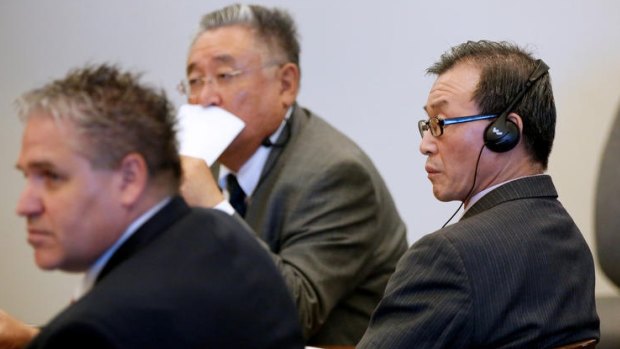 Beong Kwun Cho, far right, listens to testimony through an interpreter while next to his attorney, Robert Kohler, far left, during his trial.