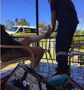 The man receiving treatment for cuts to his legs in the roo attack.