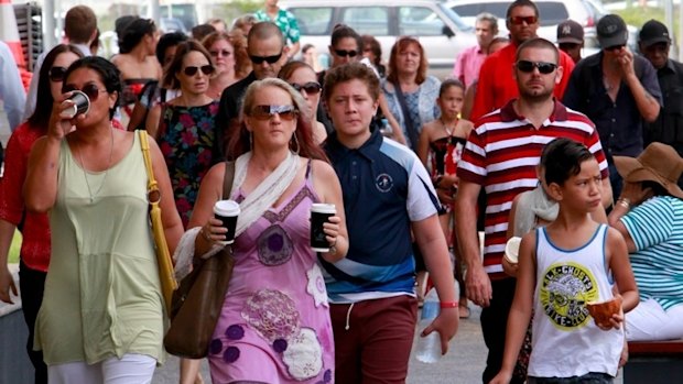 People arriving at Cairns Convention Centre for the funeral of eight children.