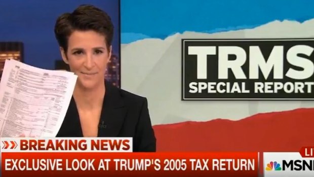 MSNBC host Rachel Maddow holds up the documents purported to be Donald Trump's tax return.