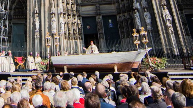 Standing in a boat recovered from Malta, Cardinal Rainer Maria Woelki told the crowd that anyone who lets people drown lets God drown.