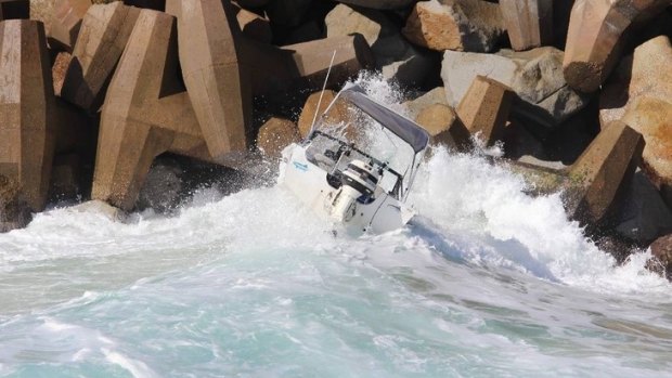 A boat was tossed back into the rocks on the southern breakwater after failing to make it  across the Narooma bar on Monday morning.