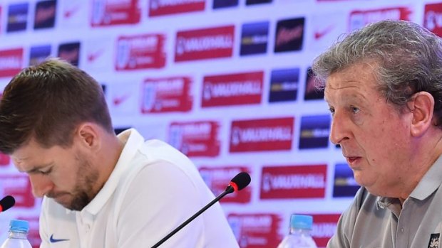 Looking for answers: England's Steven Gerrard and coach Roy Hodgson address a press conference.