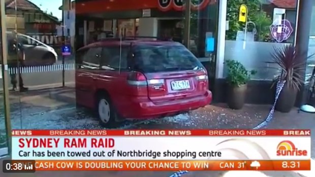The car used during a ram raid is removed from Northbridge Plaza shopping centre.