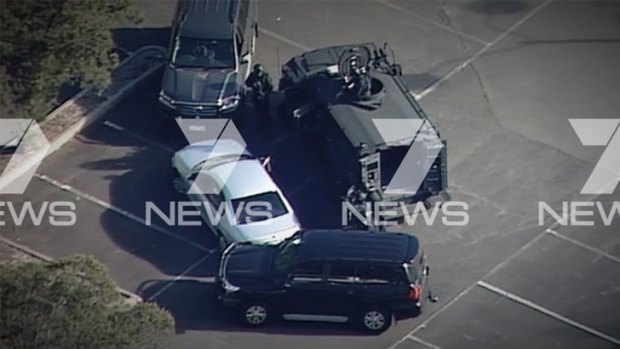 Police surround the car during the dramatic stand-off in Mooroolbark.