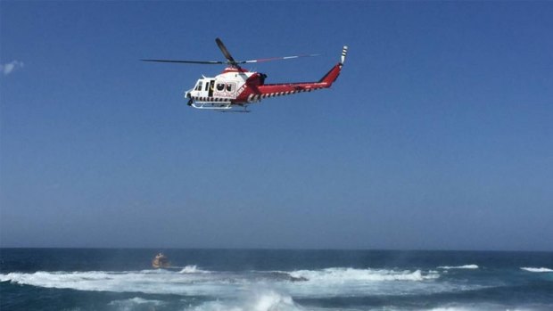 The HEMS4 rescue helicopter searches the Warrnambool breakwater.