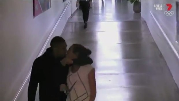 Nick Kyrgios and Ajla Tomljanovic kiss in the corridor behind Rod Laver Arena.
