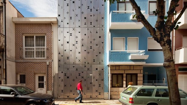 House 77 in Portugal is covered in aluminium shutters.