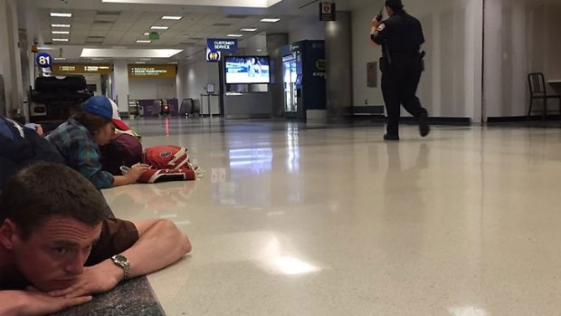 Passengers on the ground as police search LAX for the reported shooter.
