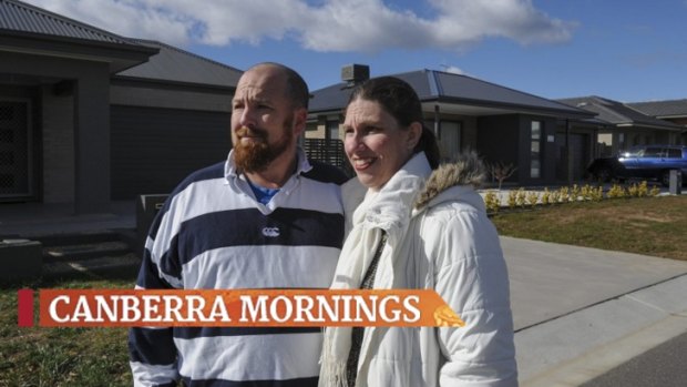 Ian and Katrina Hughes outside their home in Googong, where prices are close to half what they are in the ACT.