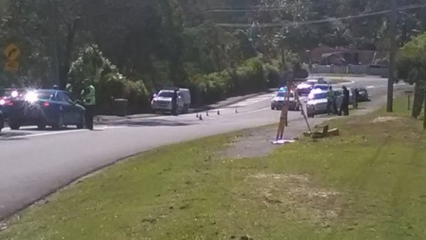 Police cordon off Tallai Road in the Gold Coast hinterland after a man was found unconscious. 