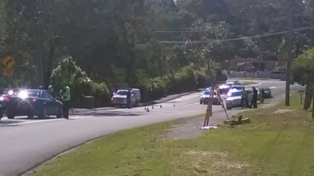 Police cordon off the Gold Coast road where a man was found unconscious.