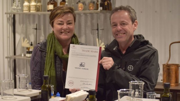 Edwina and Louis Scherini celebrate their trademark triumph, certification in hand.